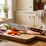 Castmoor Damascus chef knife with sliced vegetables